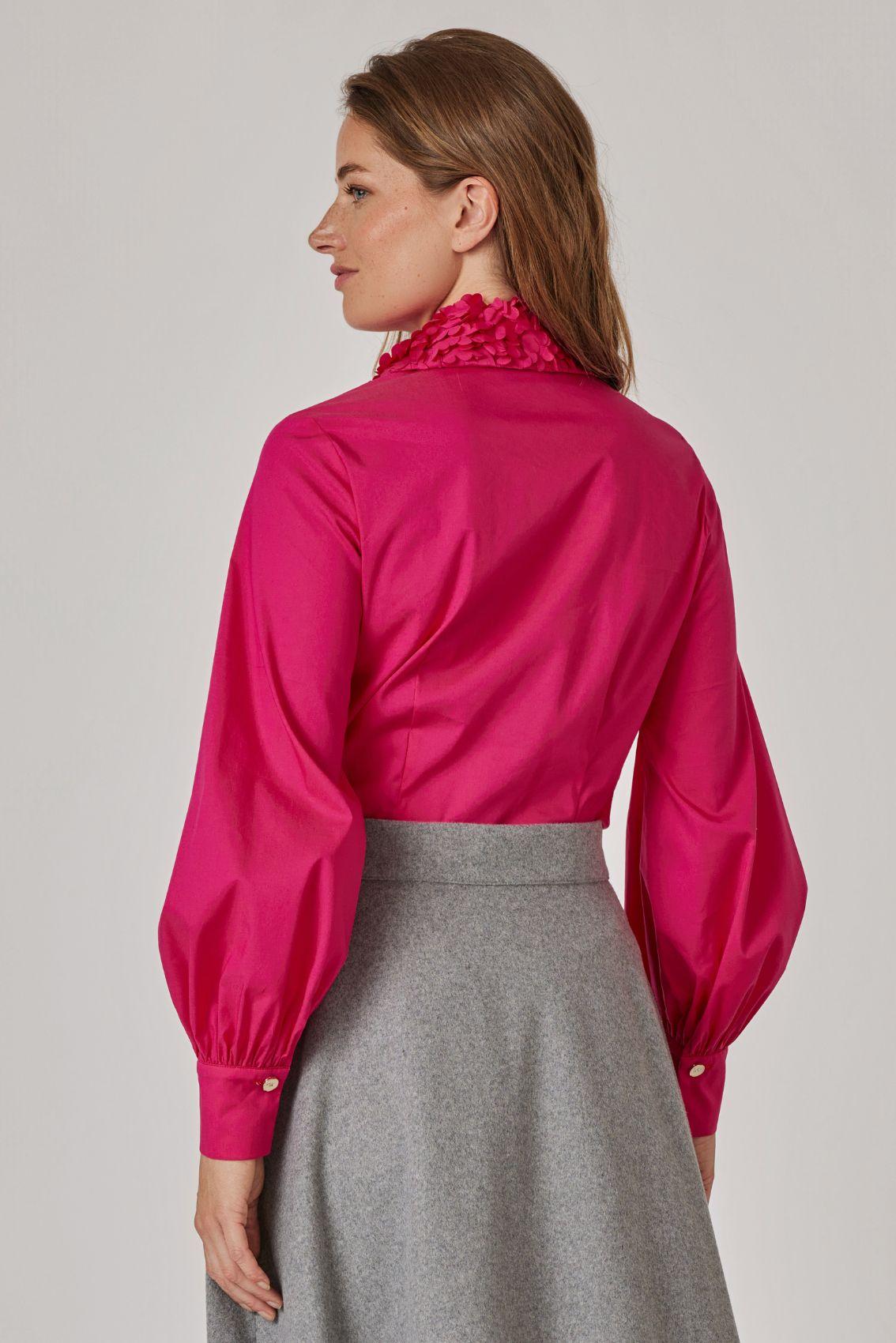 Model trägt Bluse in Magenta, Rückansicht mit geraffter Manschette
